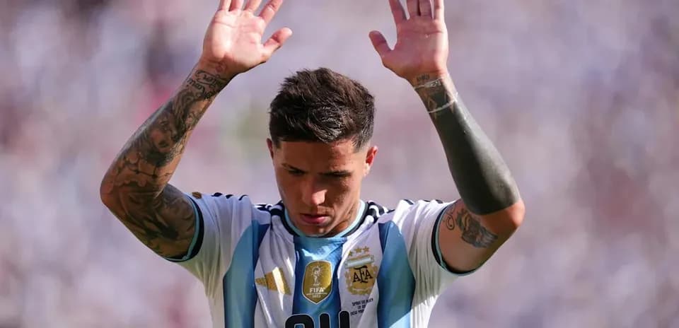 Player raising hands during match with Argentina jersey