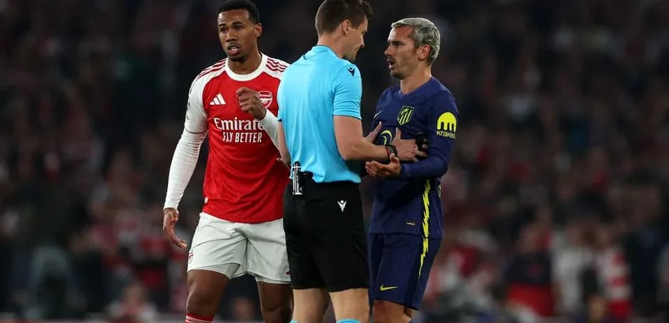 Players and referee discussing during match action