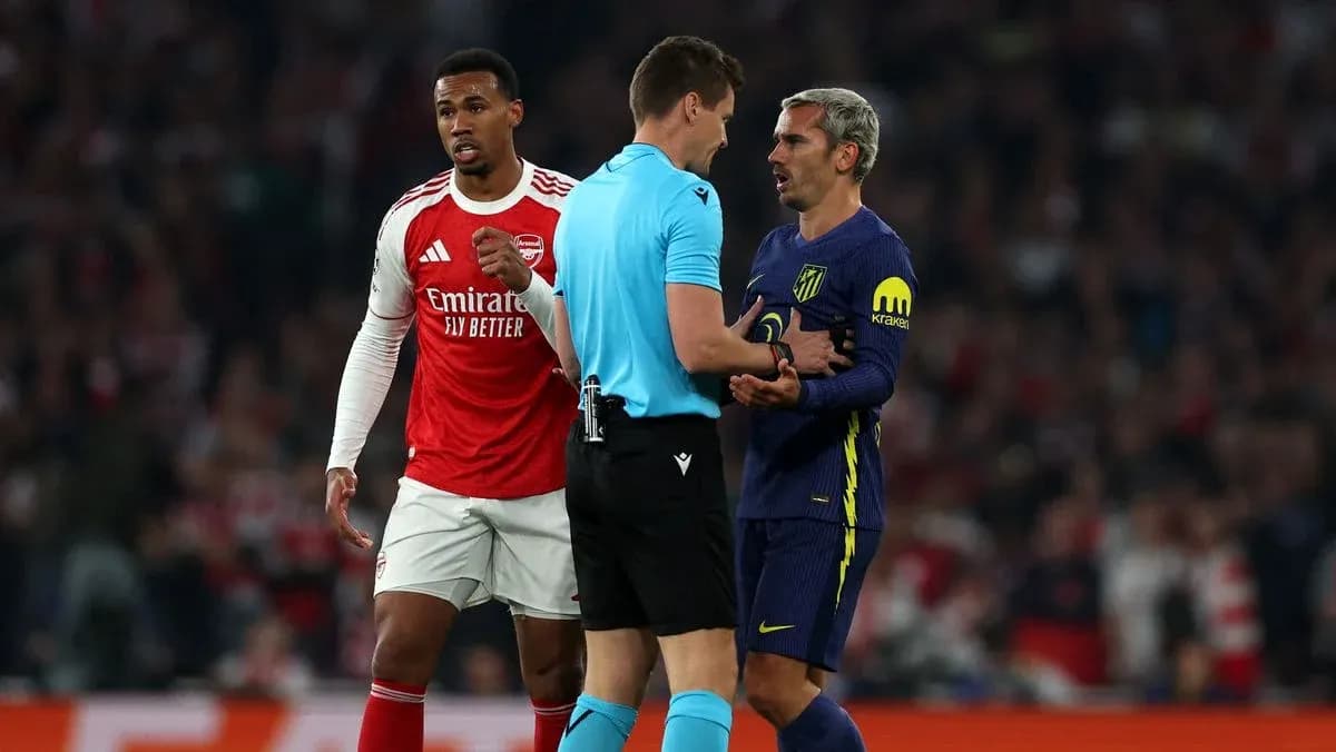 Players and referee discussing during match action