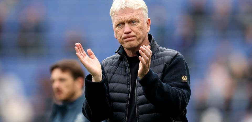 Manager clapping during match warm-up on field