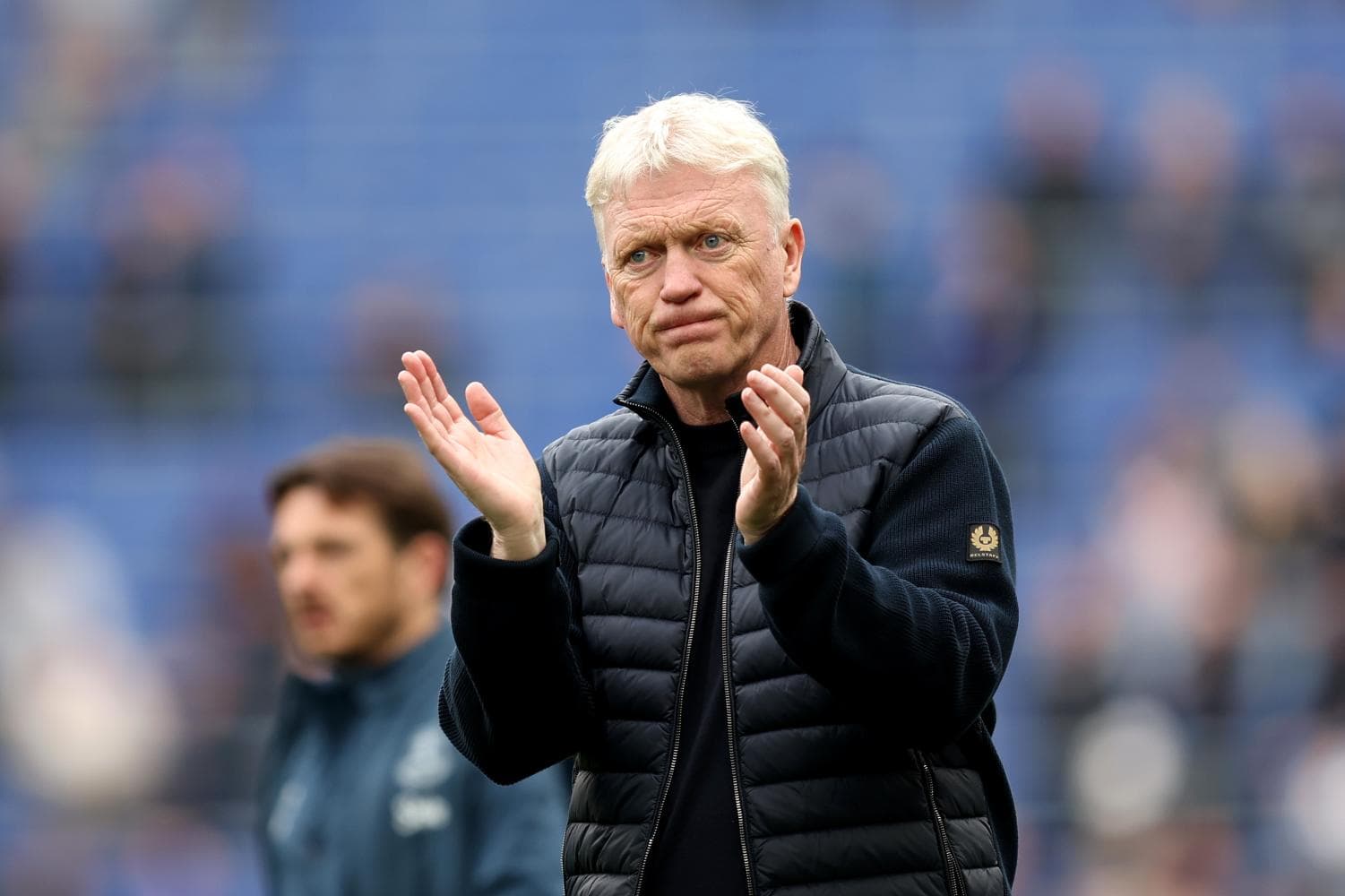 Manager clapping during match warm-up on field