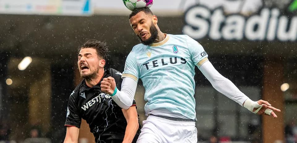 Players competing for the ball during Pacific FC match