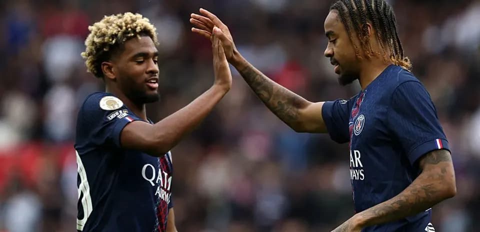 Two PSG players celebrating with a high five