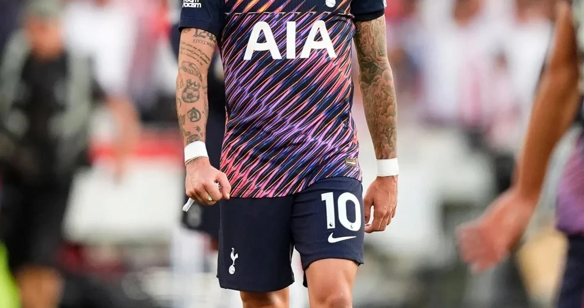 Player in Tottenham kit walking on the pitch