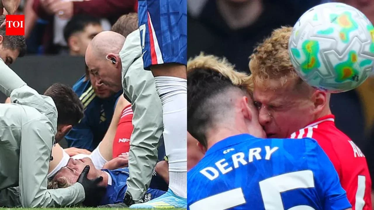 Players receiving medical attention and collision during match