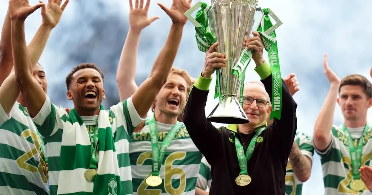 Team celebrating trophy victory with manager holding cup