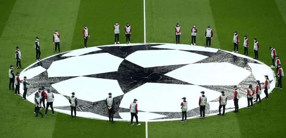 Staff preparing UEFA Champions League logo on field