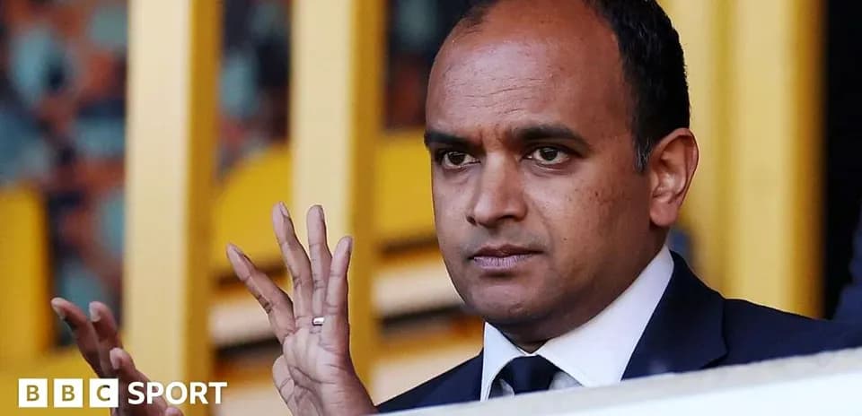 Man gesturing in sports venue stands
