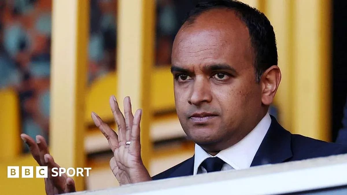 Man gesturing in sports venue stands
