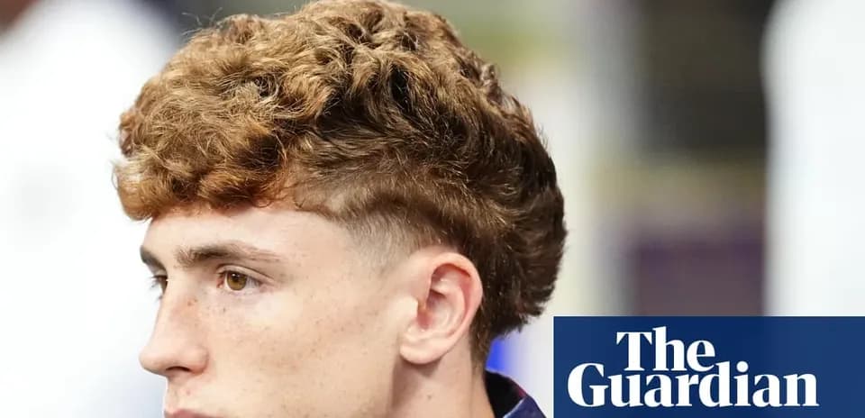 Young man with curly hair looking sideways