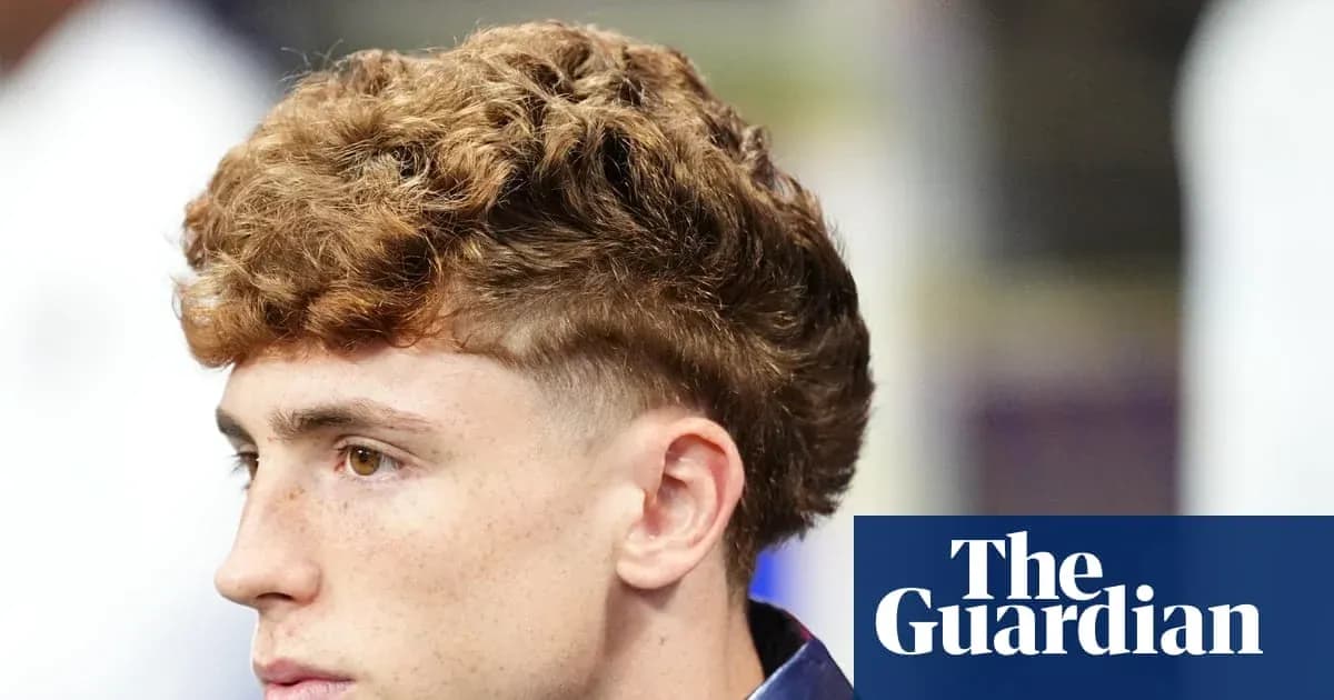 Young man with curly hair looking sideways