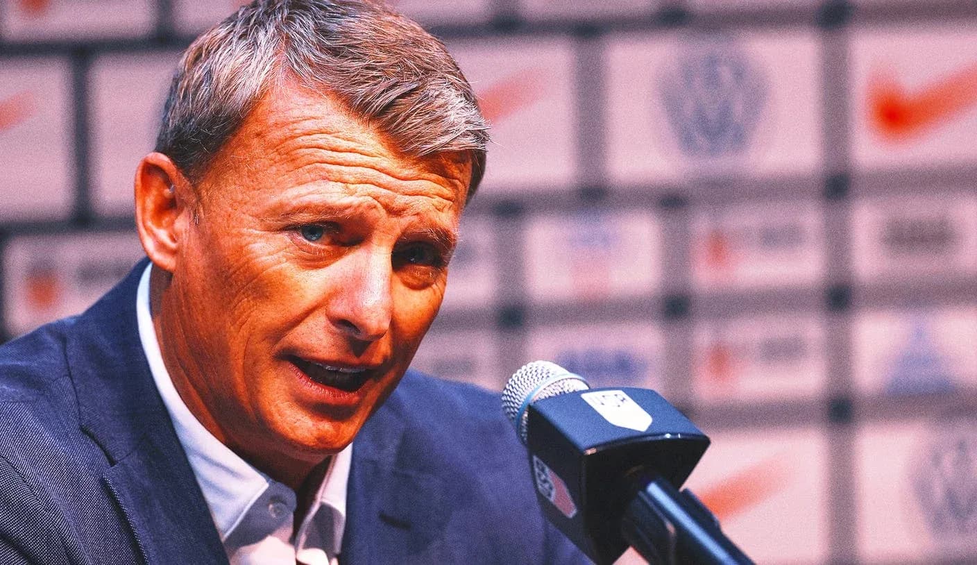 Manager speaking at press conference with microphone