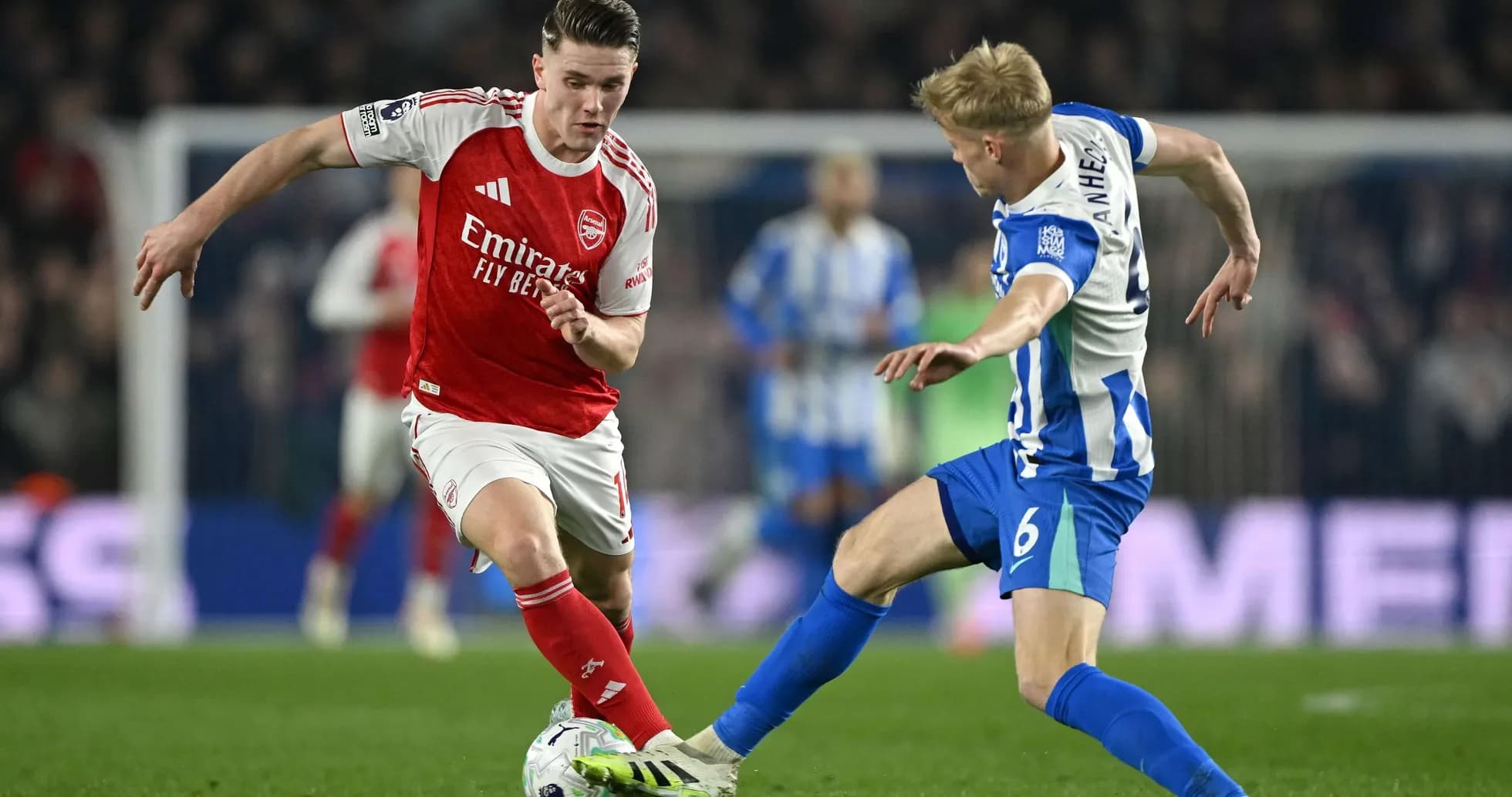 Brighton player tackling Arsenal midfielder during match