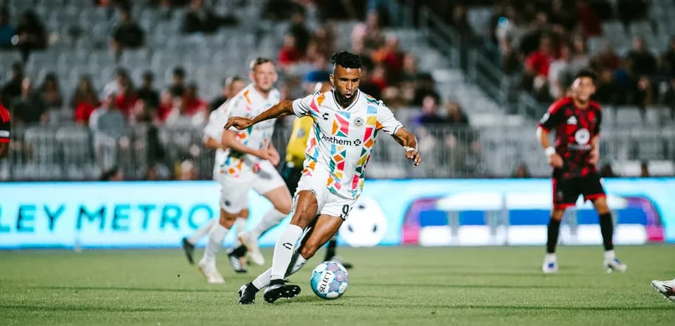 Player dribbling the ball during football match