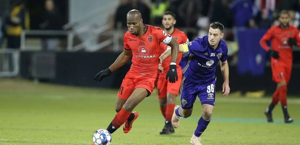 Player dribbling the ball during USL Championship match