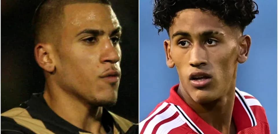Two football players in different kits facing camera