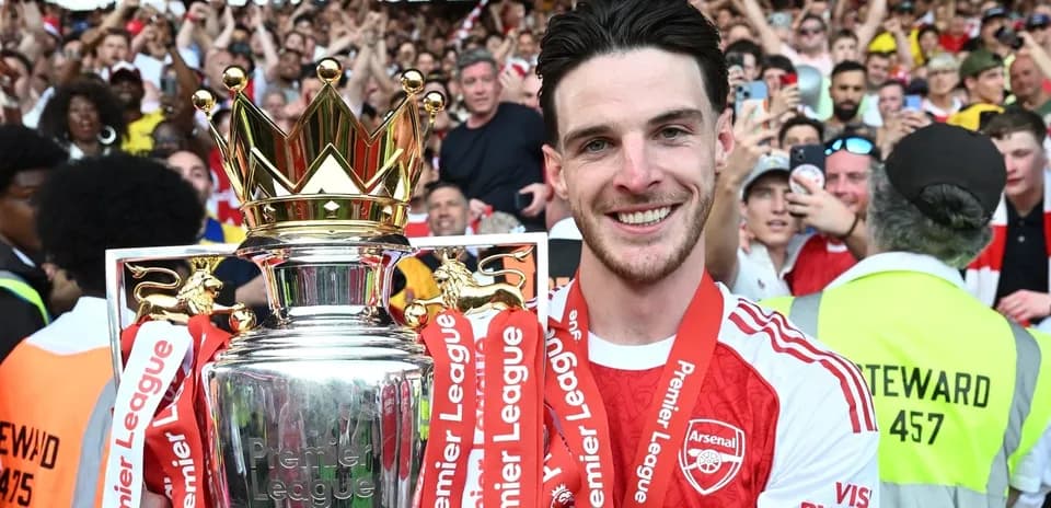 Player celebrating with Premier League trophy and fans