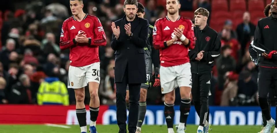 Manchester United players and staff applauding fans