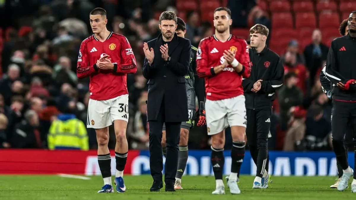 Manchester United players and staff applauding fans