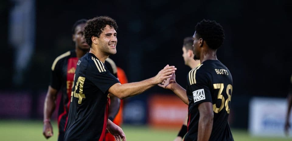 Players celebrating during Huntsville City match