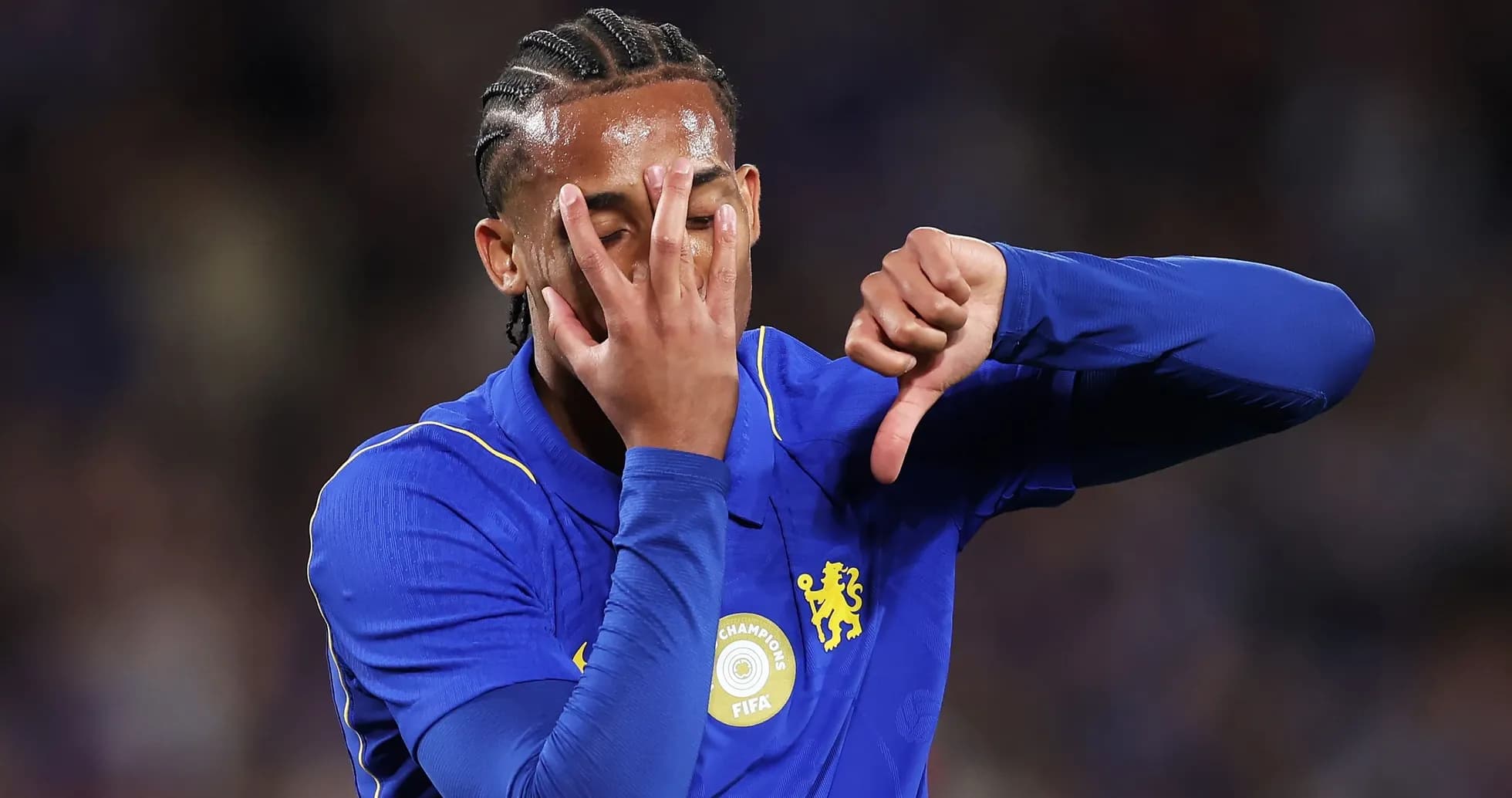 Player in blue jersey making a gesture during match