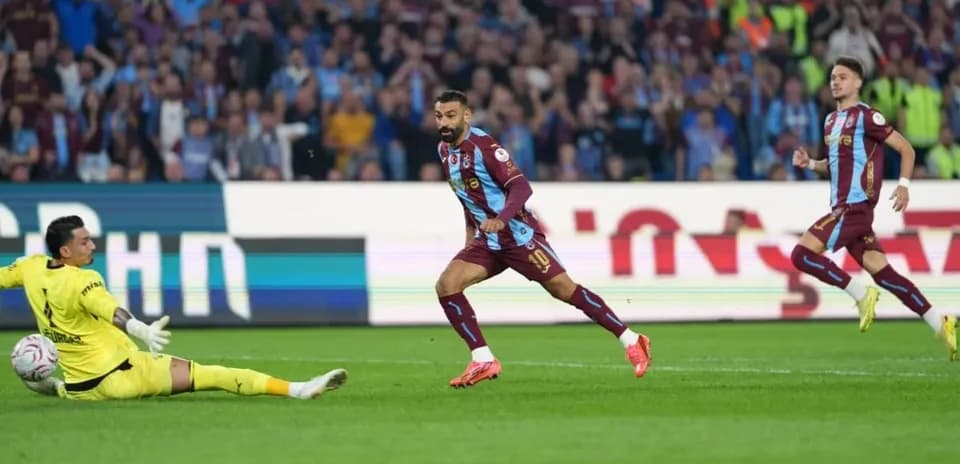 Player celebrating after scoring against the goalkeeper