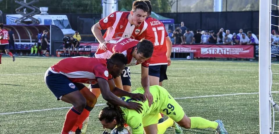 Players celebrating after a goal during match