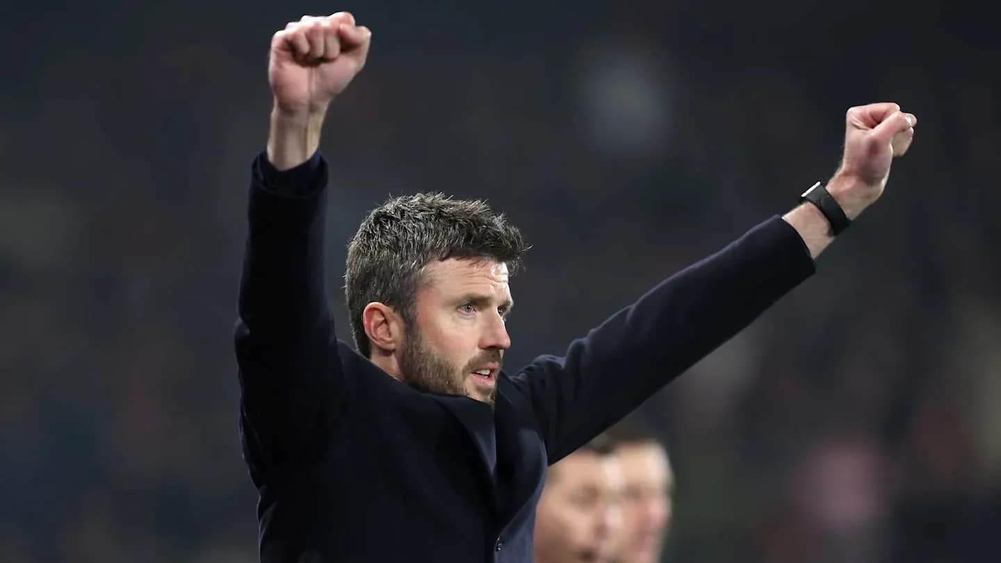 Coach celebrating with raised arms during match