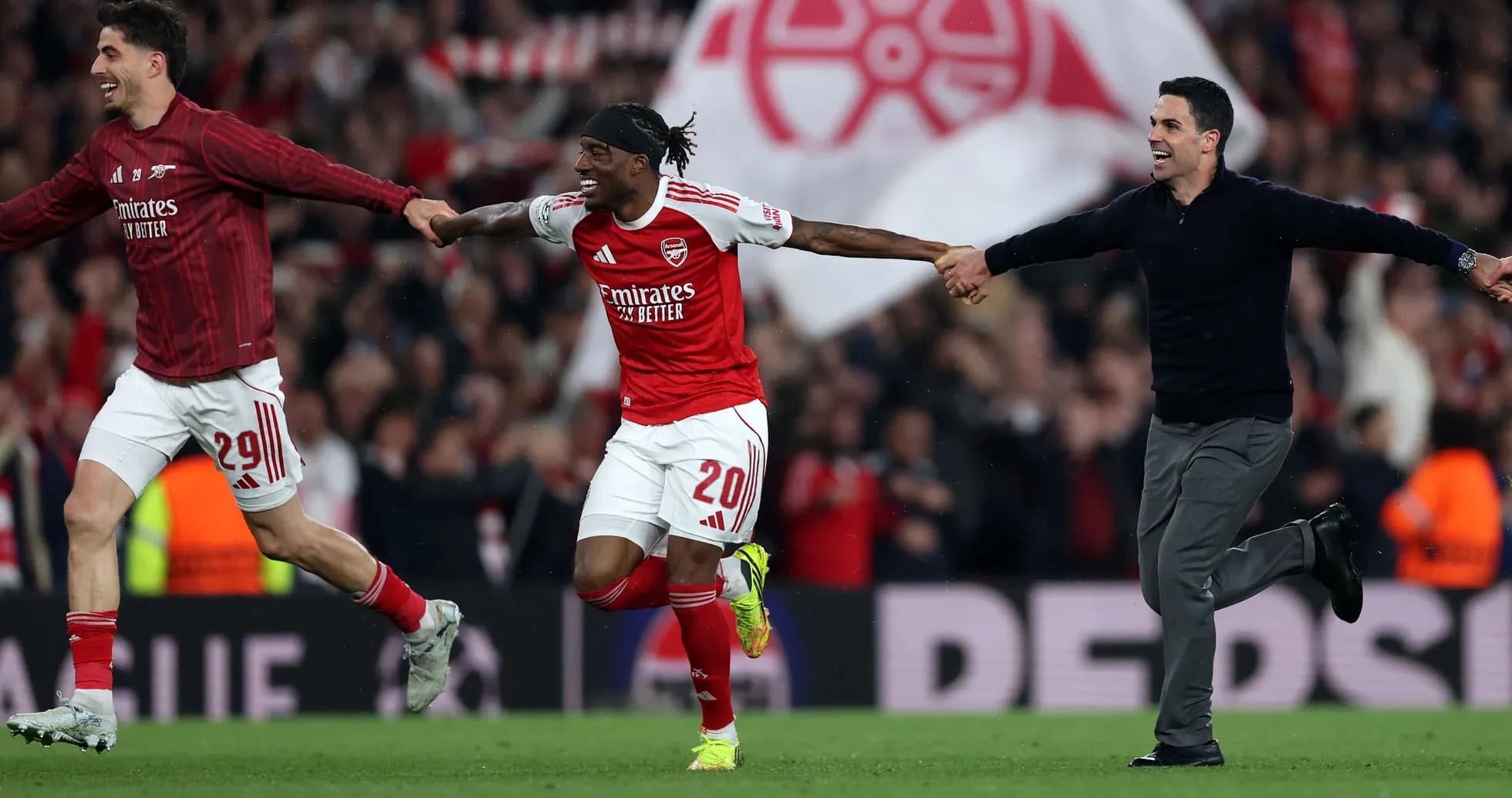 Arsenal players celebrating a goal on the pitch