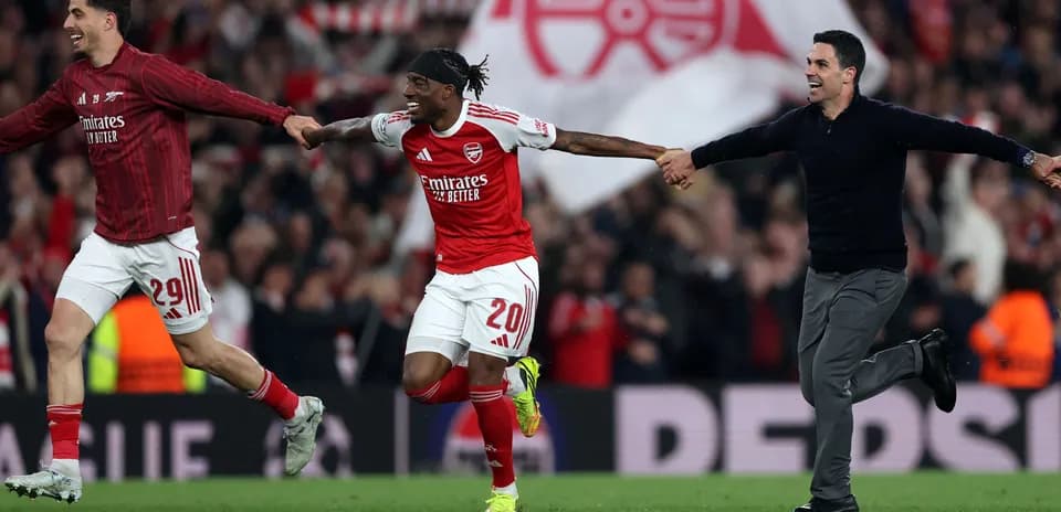 Arsenal players celebrating a goal on the pitch