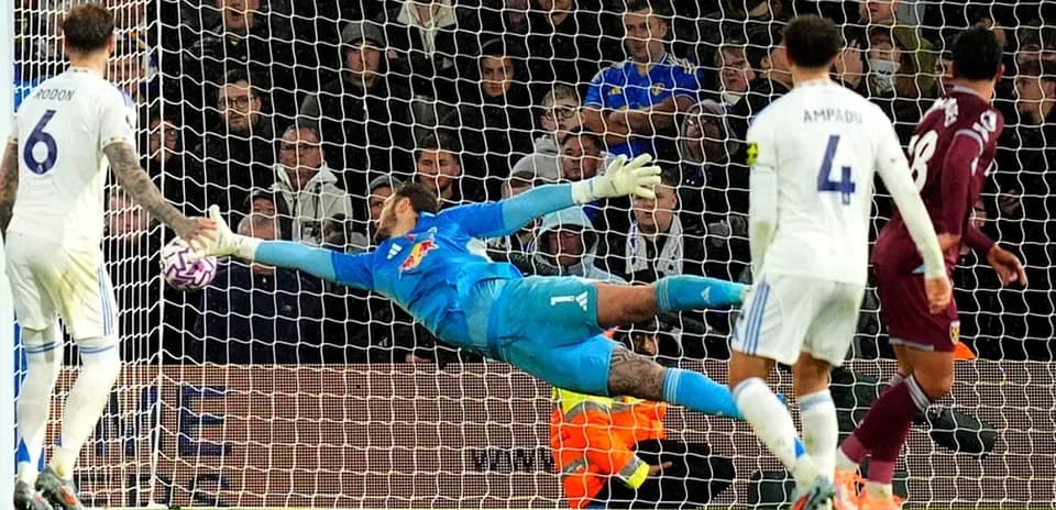 Goalkeeper diving to save a shot on goal