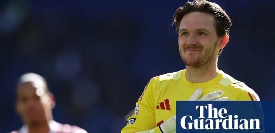 Goalkeeper in yellow kit smiling on the field