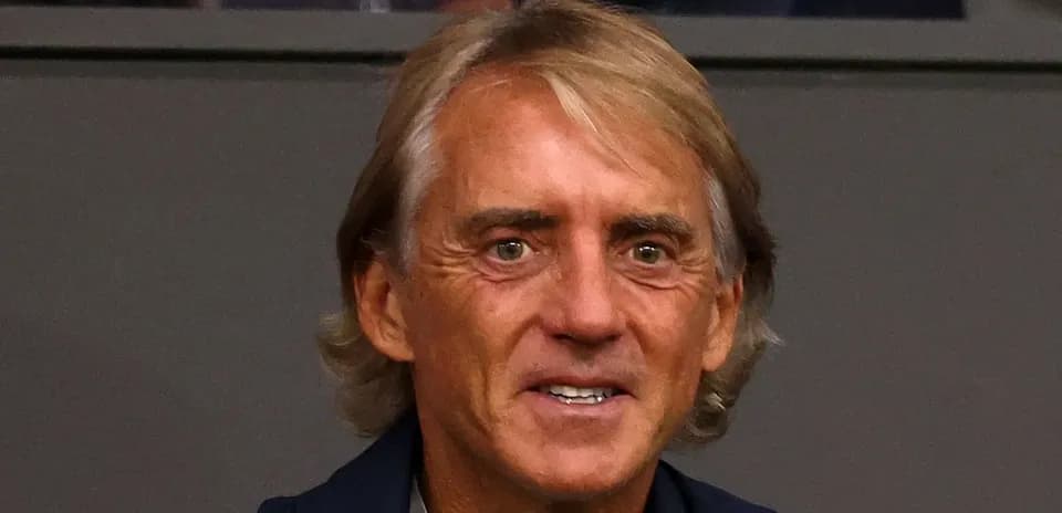 Man with light brown hair smiling at camera