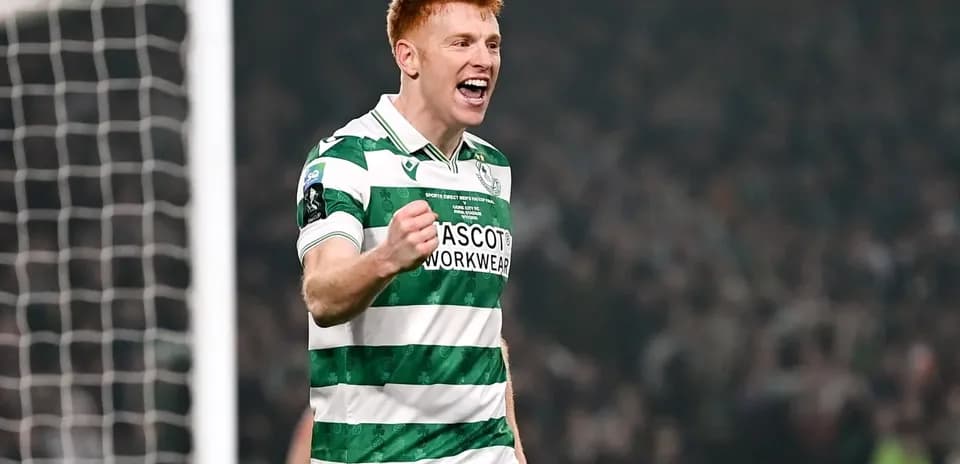 Player celebrating a goal in green and white jersey