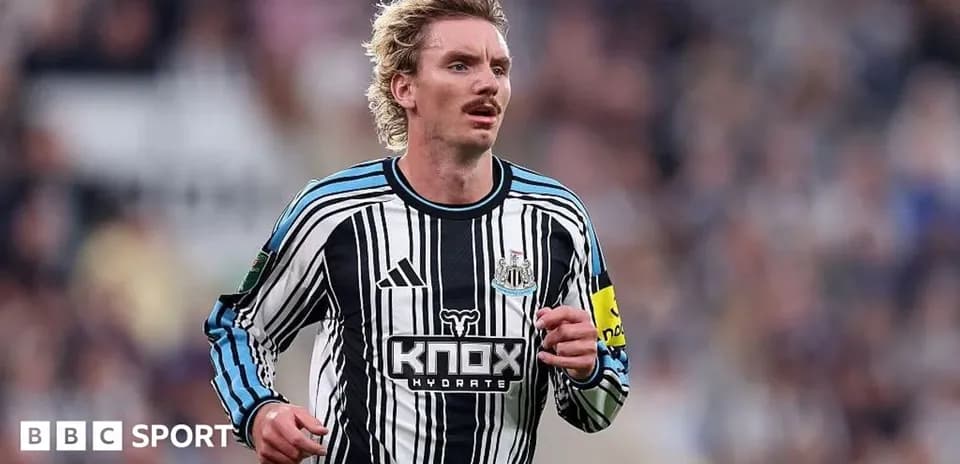 Player running on the pitch in Newcastle kit