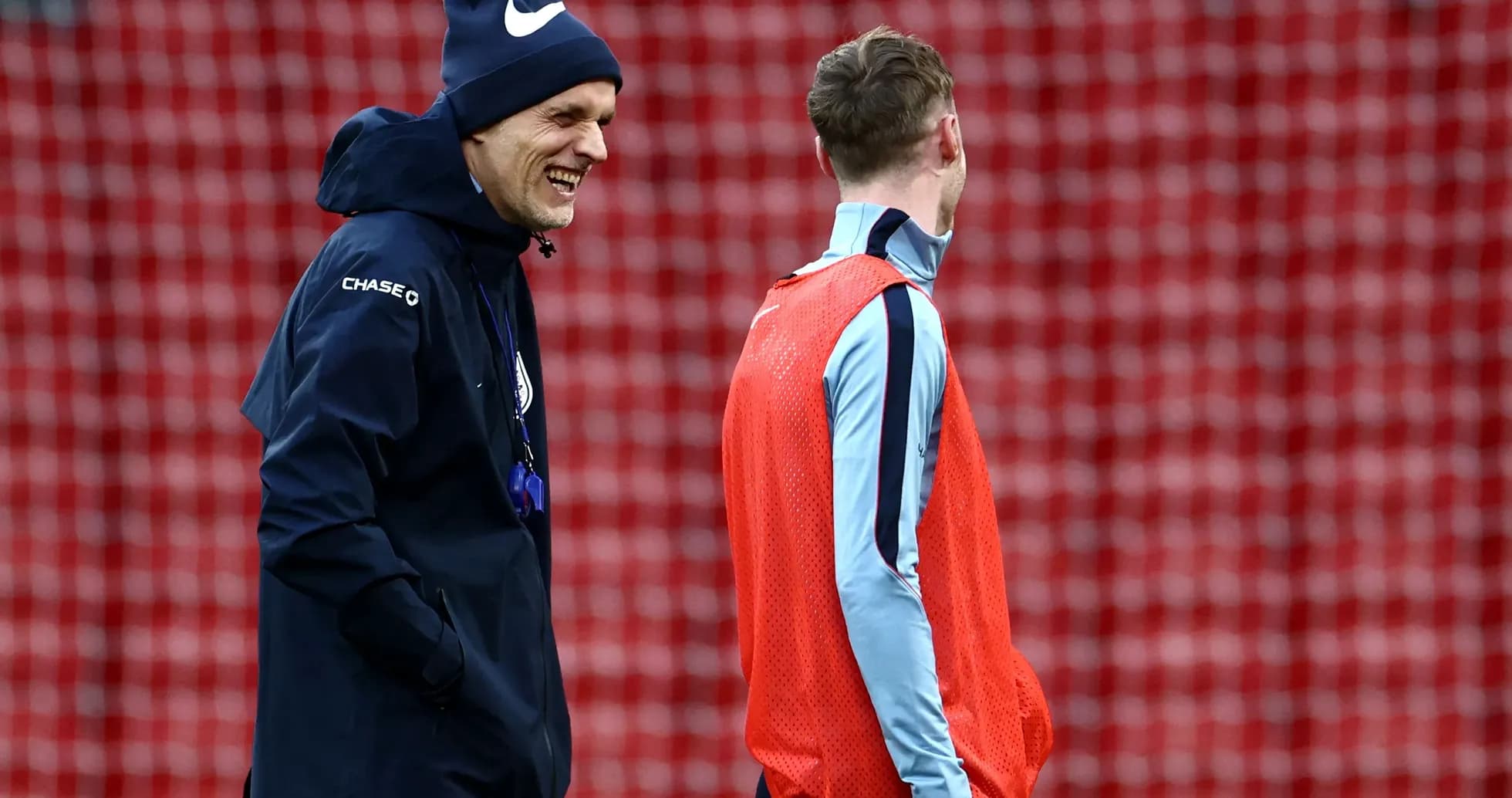 Coach and player chatting during training session