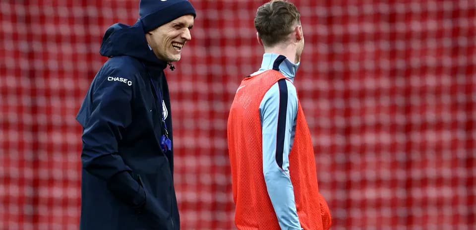 Coach and player chatting during training session