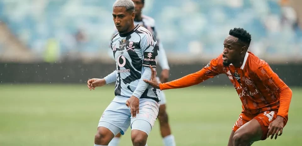 Player dribbling while being challenged by opponent