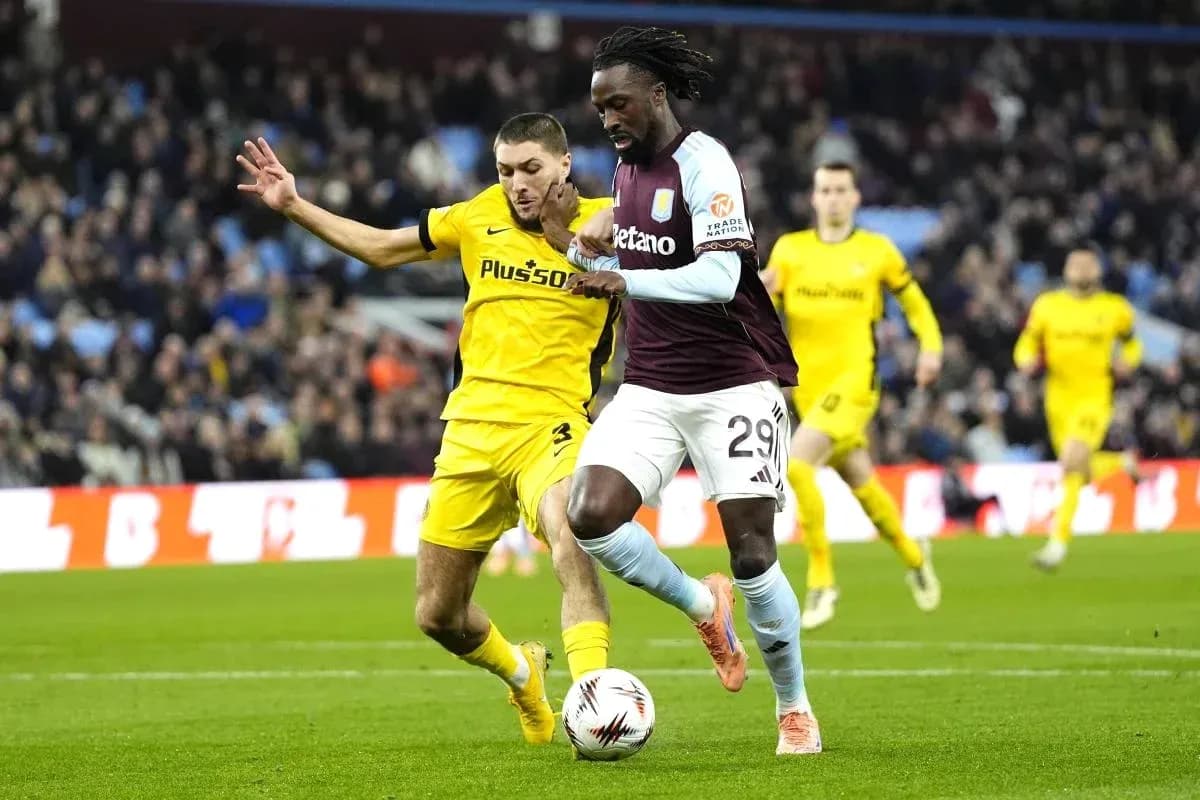 Player from Aston Villa dribbling past opponent during match