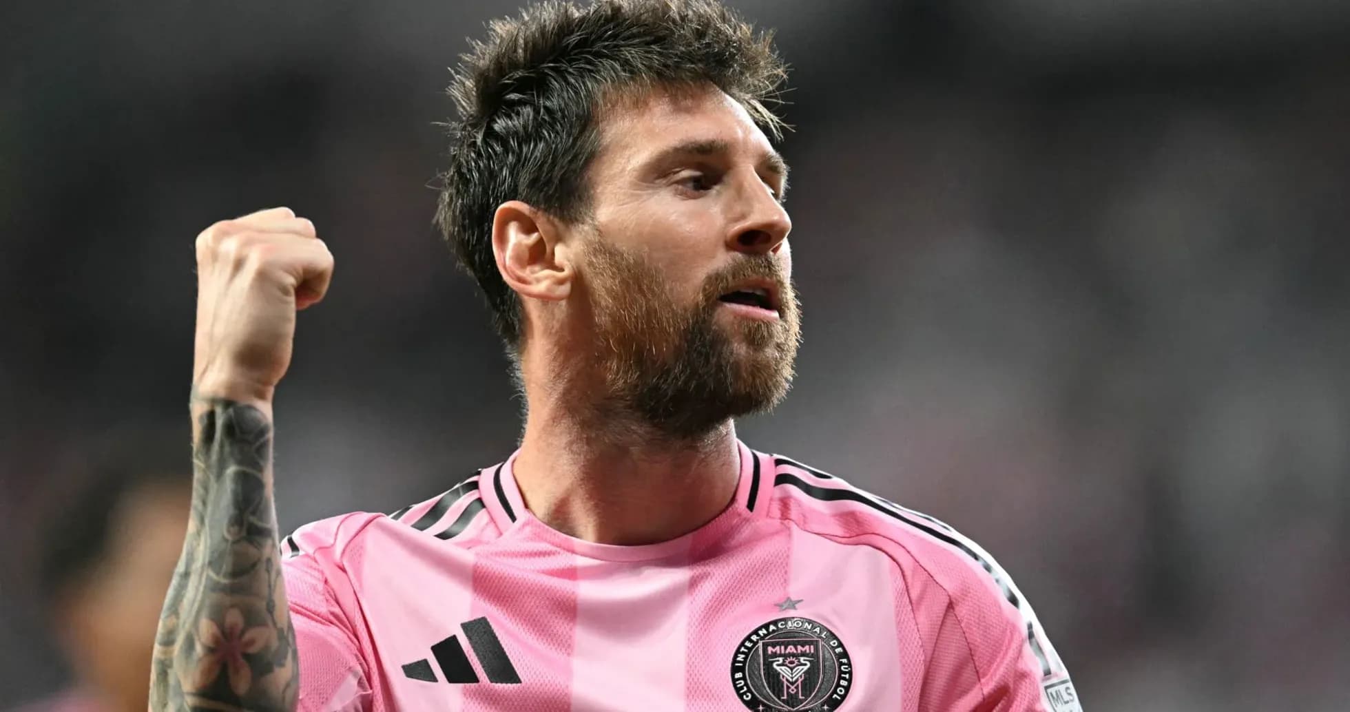 Player celebrating in pink jersey during match