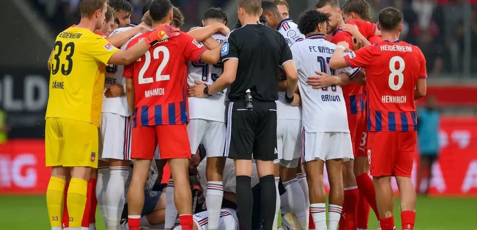 Players from both teams huddled together on field