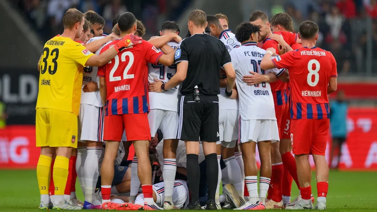 Players from both teams huddled together on field