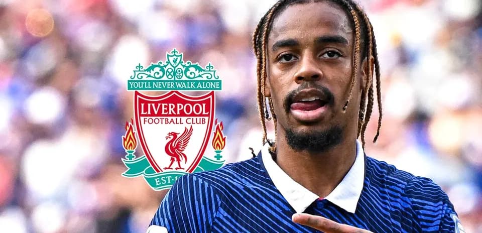 Player gesturing during match with Liverpool logo