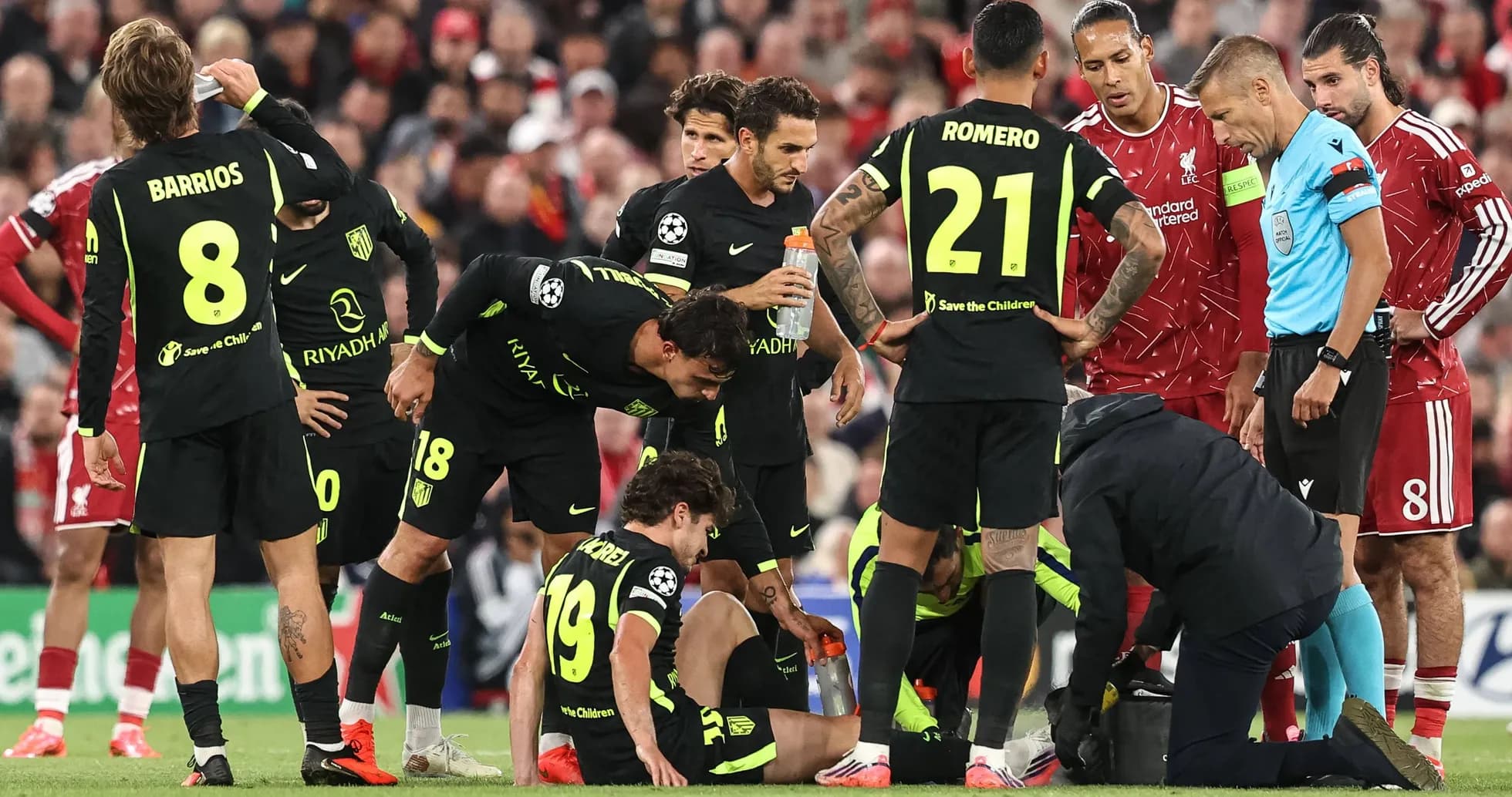 Atletico Madrid players surrounding injured teammate on field
