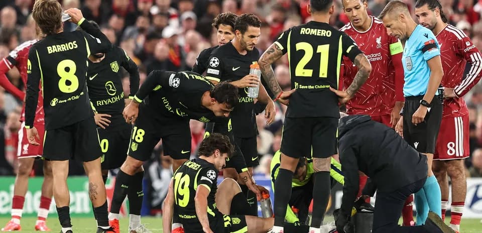 Atletico Madrid players surrounding injured teammate on field