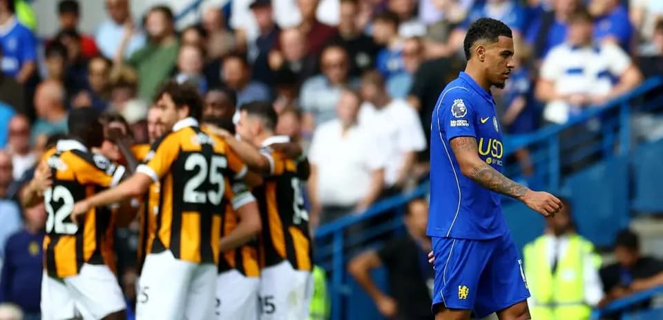 Player walking away as teammates celebrate goal