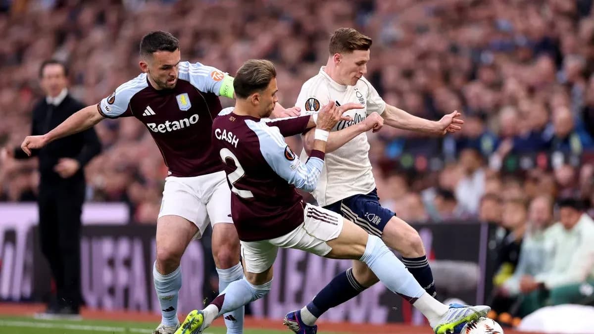 Two Aston Villa players tackling opponent during match