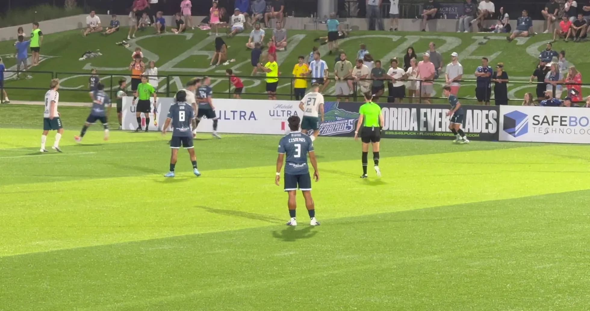 Players preparing for a free kick during match
