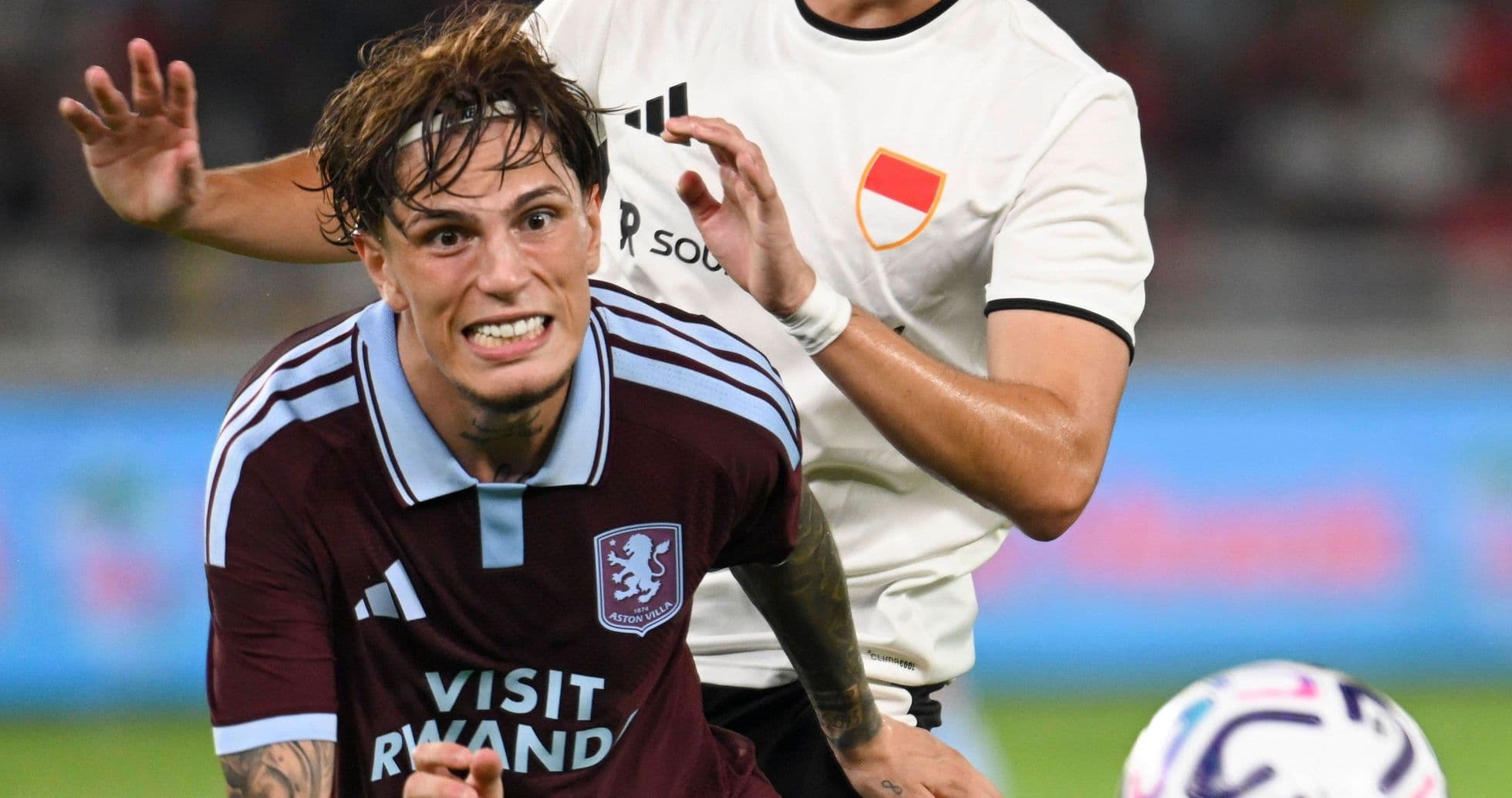 Aston Villa player being challenged by opponent