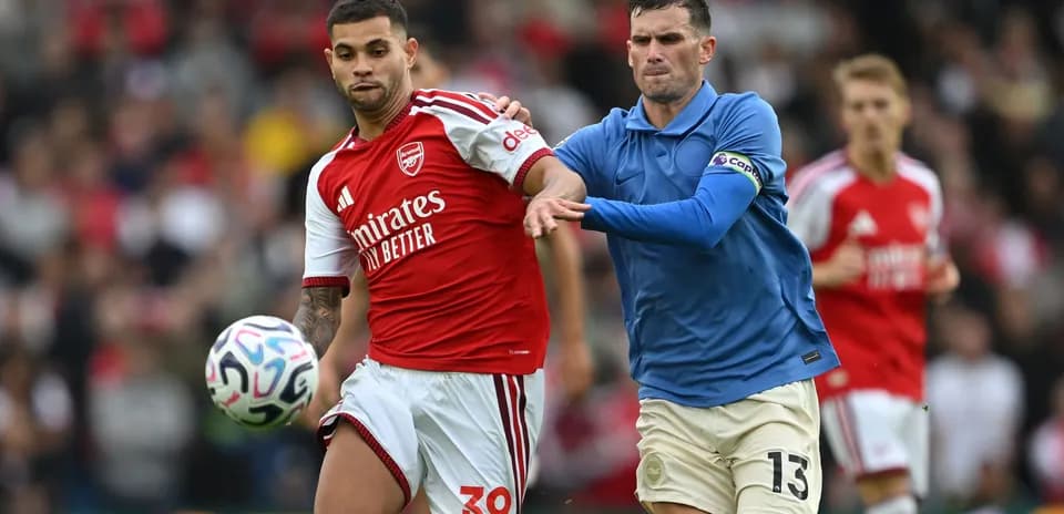 Two players contesting for the ball during match